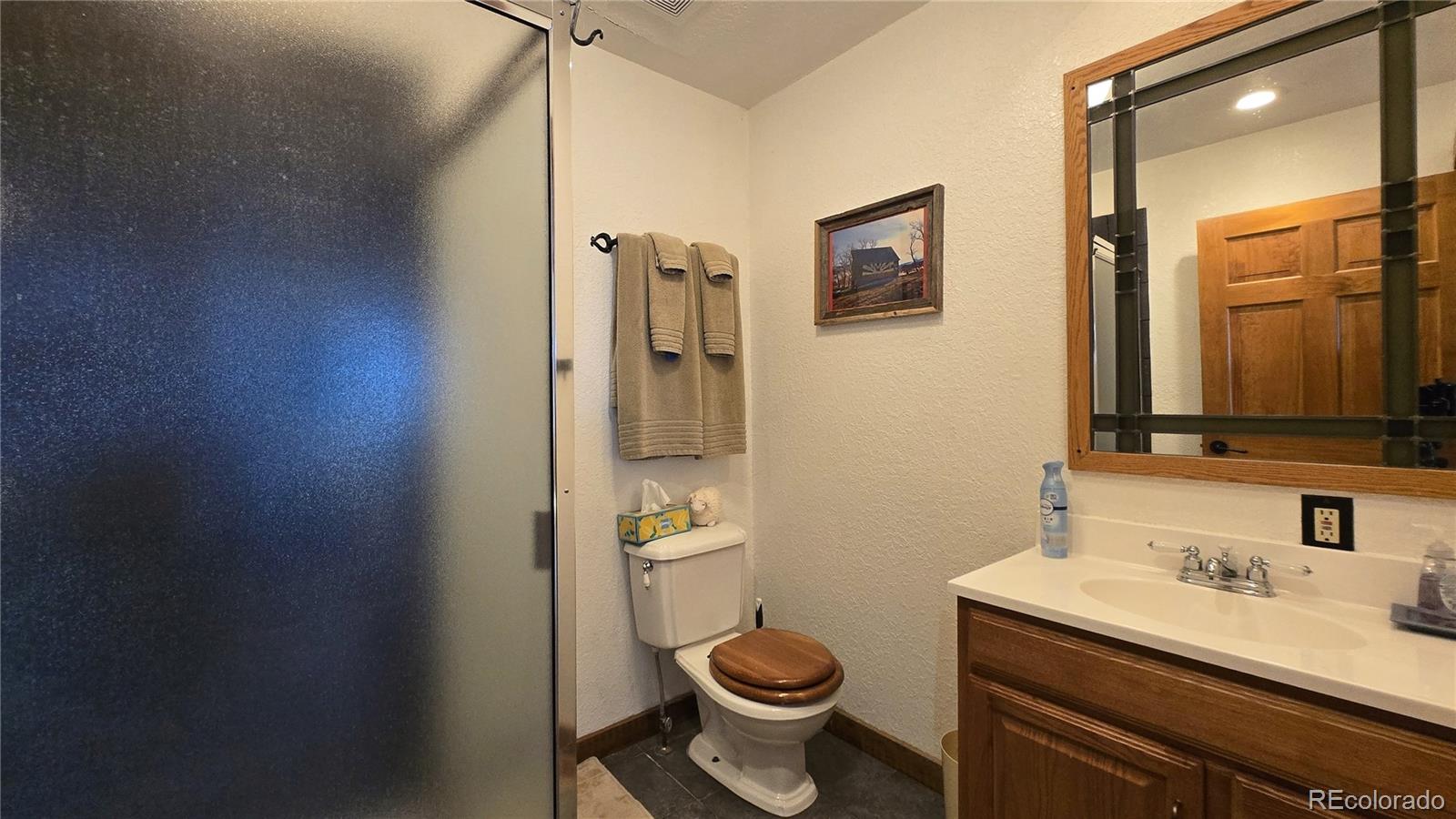 957 Vega Road Walsenburg, CO 81089 - Photo 20 of 30 a bathroom with a granite countertop toilet sink and mirror