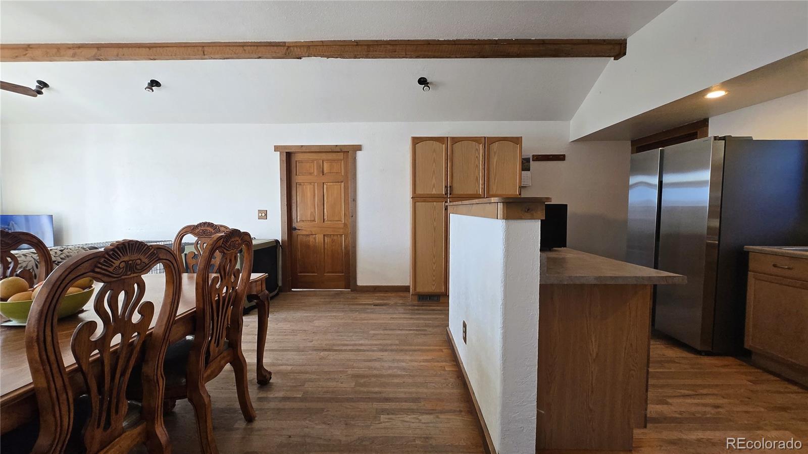 957 Vega Road Walsenburg, CO 81089 - Photo 9 of 30 a view of a dining room with furniture and wooden floor