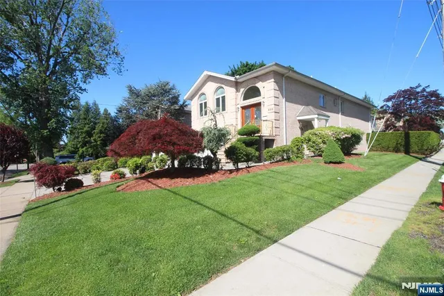 a front view of house with yard and green space