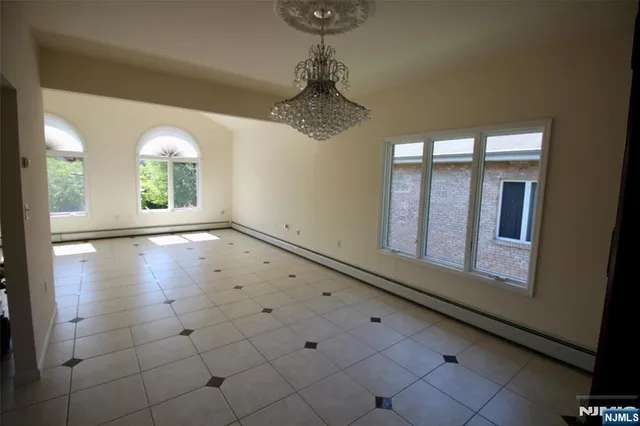 a view of a room with window chandelier fan and windows