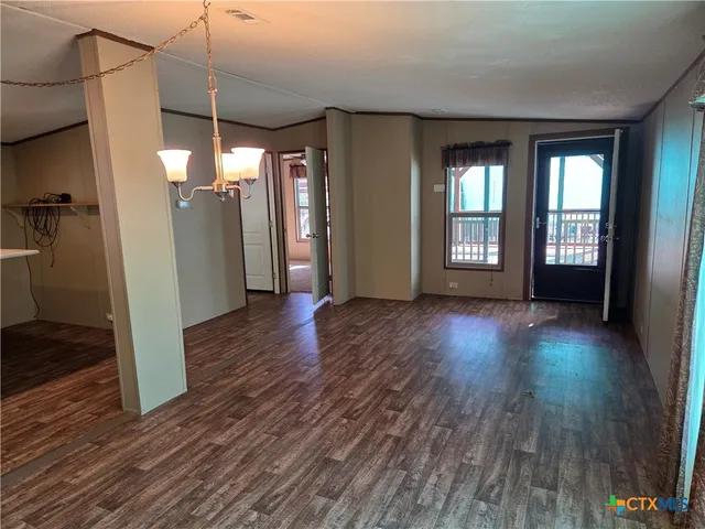 a view of a room with wooden floor and window