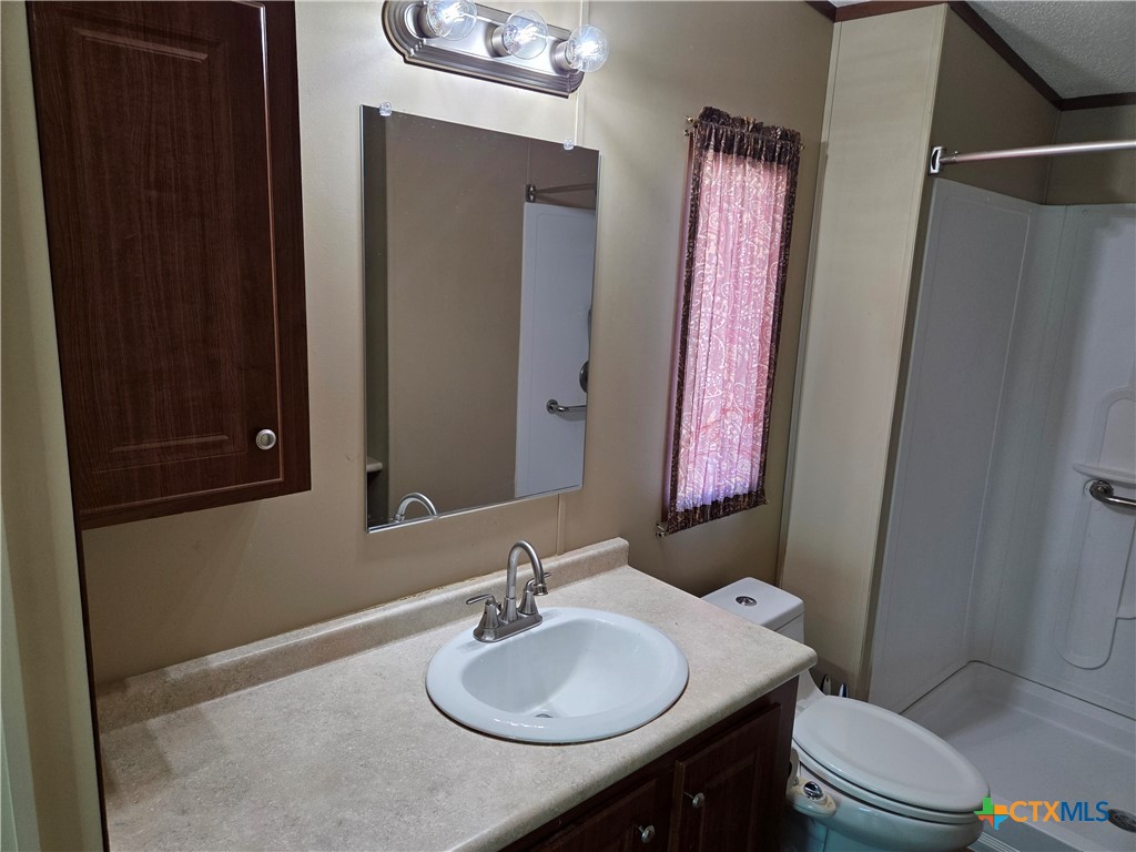 5504 Jib Lane Temple, TX 76502 - Photo 14 of 36 a bathroom with a sink vanity mirror and toilet
