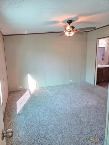 a view of a livingroom with a ceiling fan and window