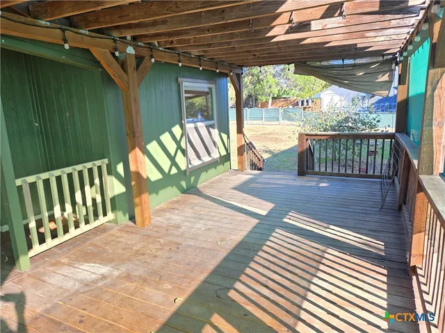 a view of a porch with wooden floor