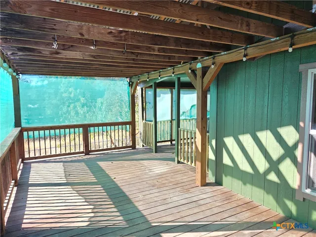 a patio with wooden floor and outdoor space