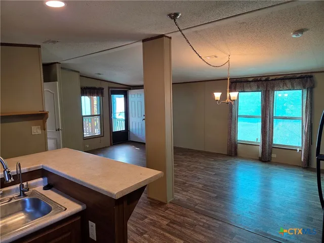 a view of a room with furniture and wooden floor
