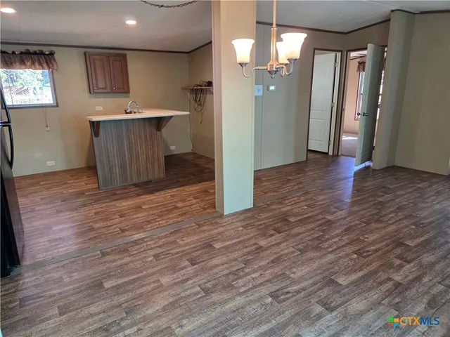 a view of kitchen and wooden floor