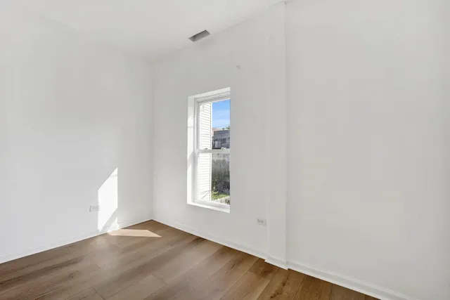 an empty room with windows and closet