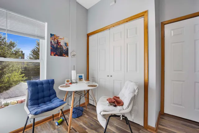a view of a room that has a table and a chair in it