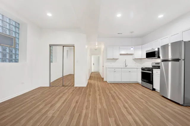 a open kitchen with white cabinets stainless steel appliances