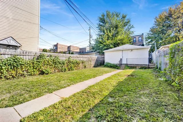 a view of a house with a big yard and potted plants