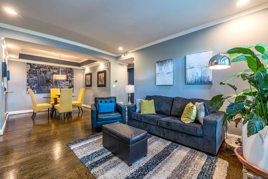 240 Renaissance Parkway Northeast, Unit 111 Atlanta, GA 30308 - Photo 1 of 1 a living room with furniture and wooden floor