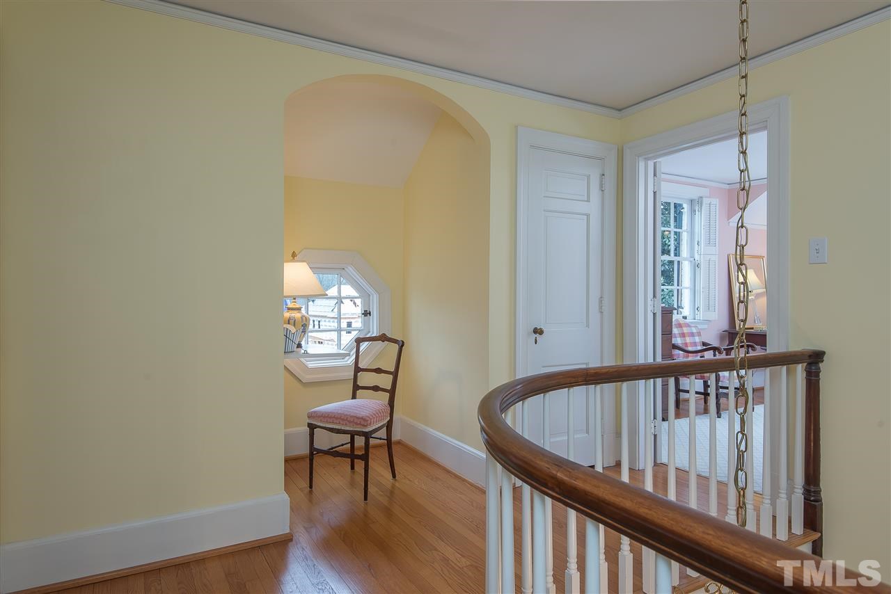2717 Cambridge Road Raleigh, NC 27608 - Photo 12 of 21 a view of a bedroom with wooden floor and a table