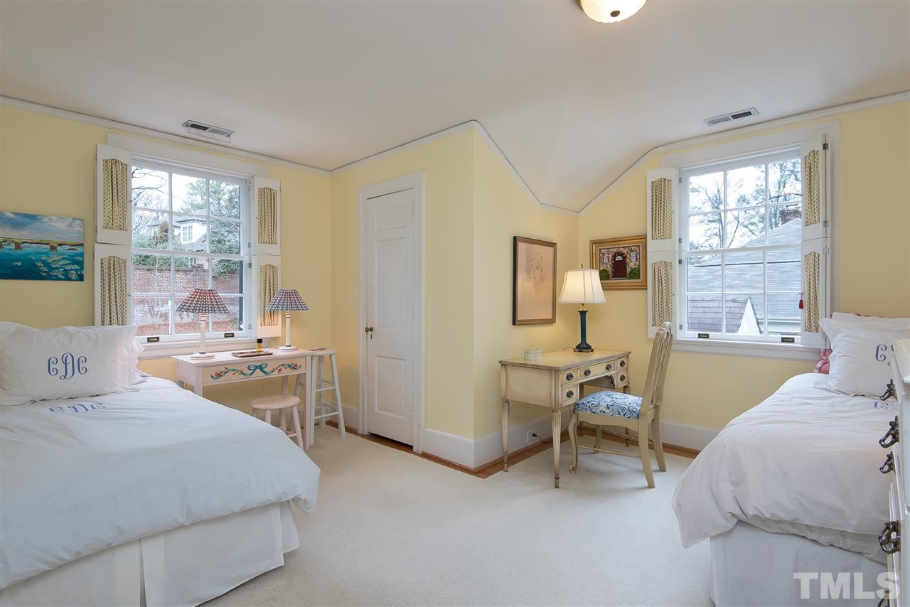 2717 Cambridge Road Raleigh, NC 27608 - Photo 15 of 21 a bedroom with a bed and large windows