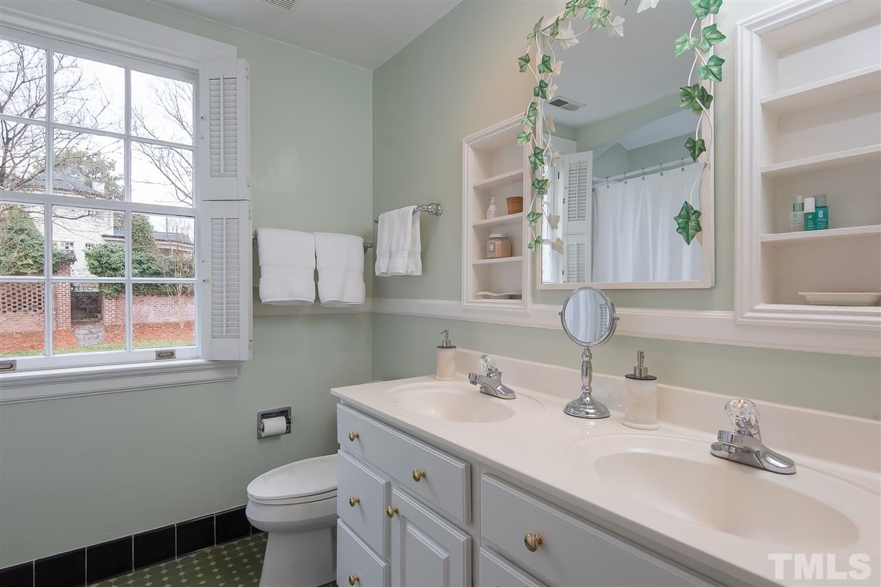 2717 Cambridge Road Raleigh, NC 27608 - Photo 17 of 21 a bathroom with a sink toilet and window