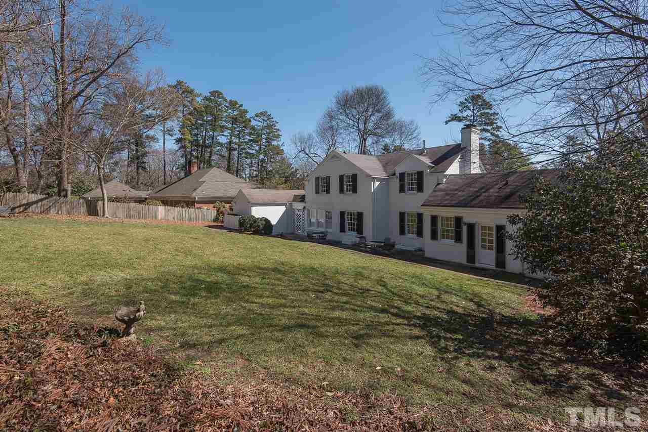 2717 Cambridge Road Raleigh, NC 27608 - Photo 18 of 21 a front view of house with yard and trees in the background