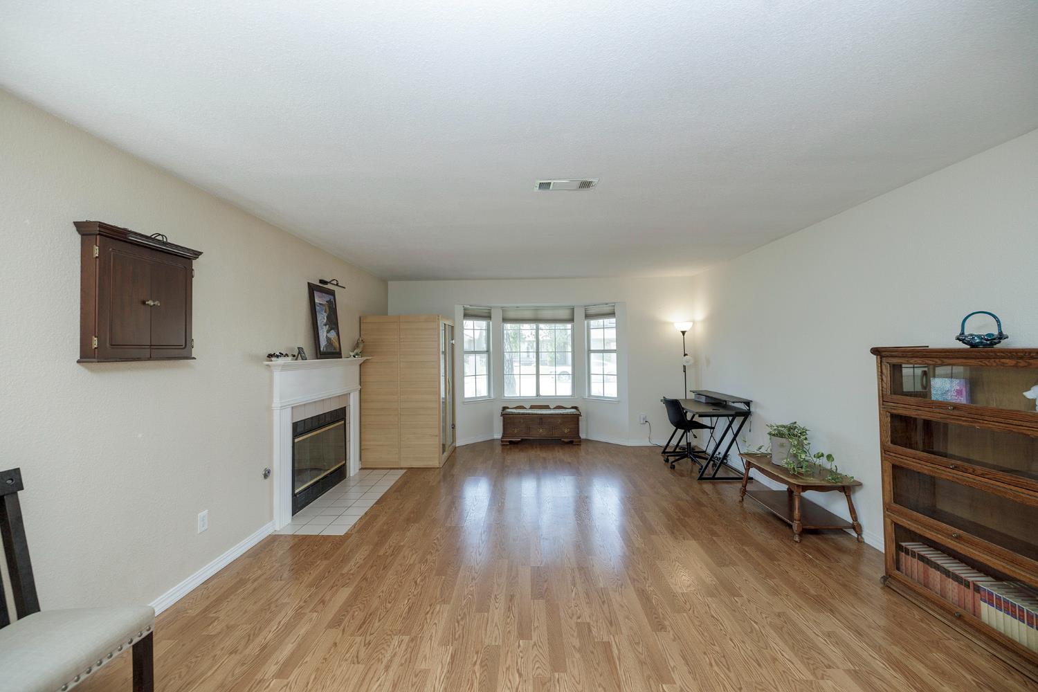 230 Meyenberg Avenue Ripon, CA 95366 - Photo 10 of 52 a view of a livingroom with furniture and a flat screen tv