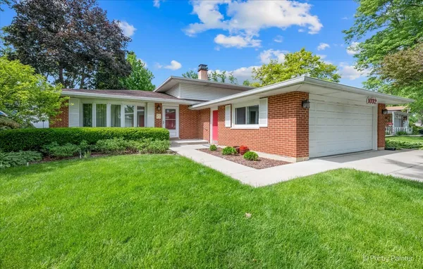a front view of house with yard and green space