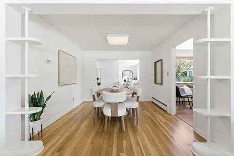 a view of a dining room with furniture and wooden floor
