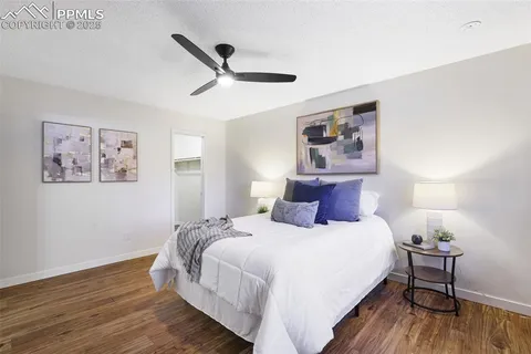 a bedroom with bed and wooden floor