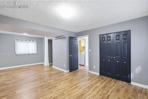 an empty room with closet and mirror