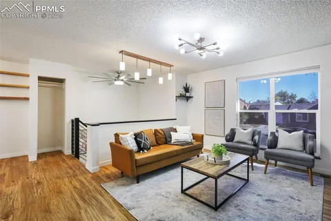 a living room with furniture and a chandelier