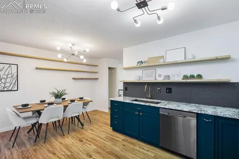 a kitchen with granite countertop a sink and stove