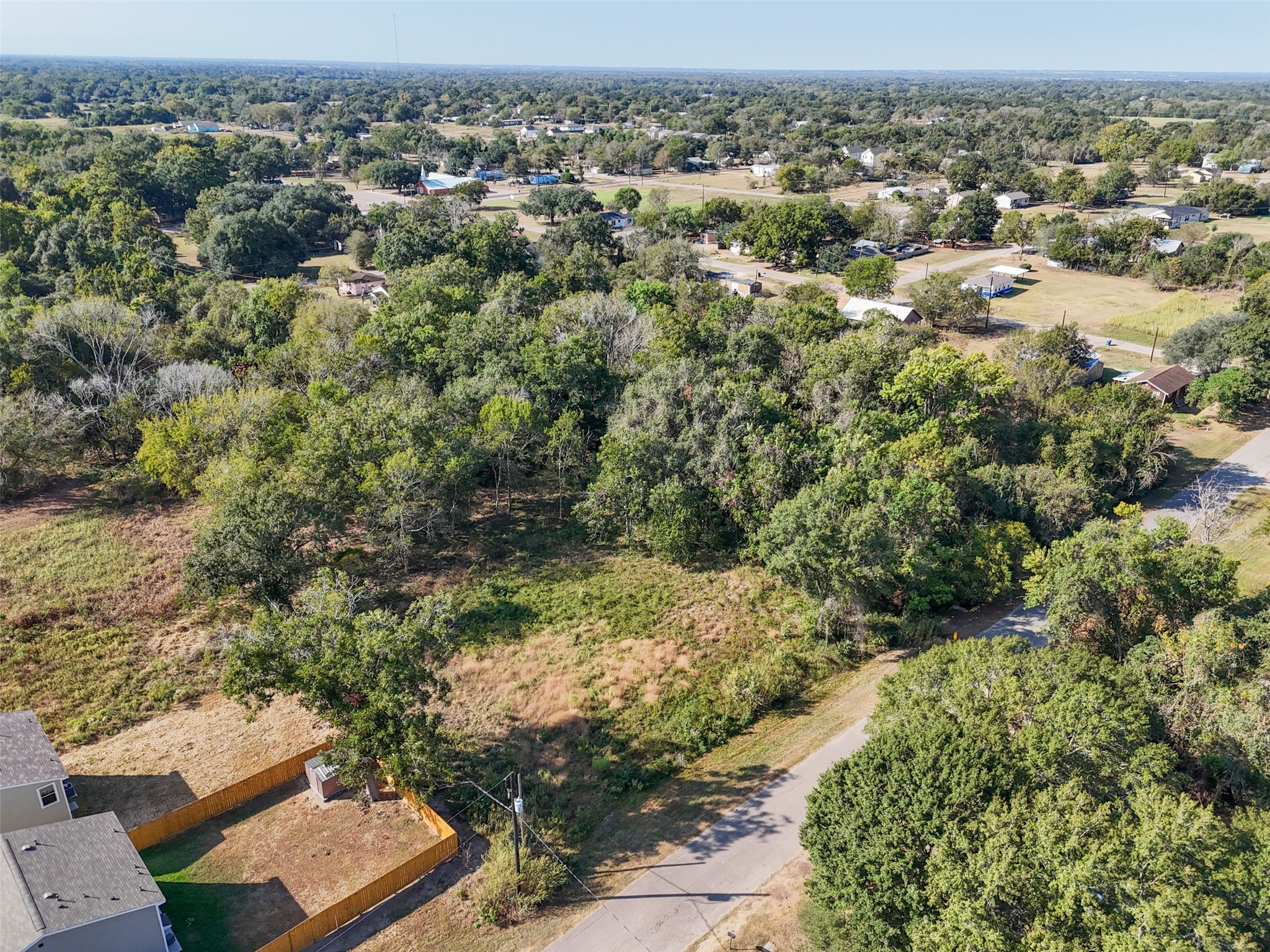 Tbd Rice Street Hempstead, TX 77445 - Photo 4 of 11 Aerial view highlighting the mix of open ground and mature trees across the tract, with Rice Street access from the north.