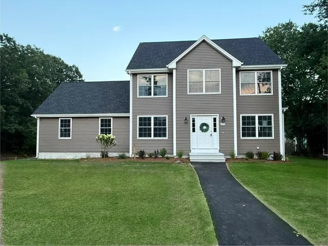 a kitchen with stainless steel appliances white cabinets a sink and a stove