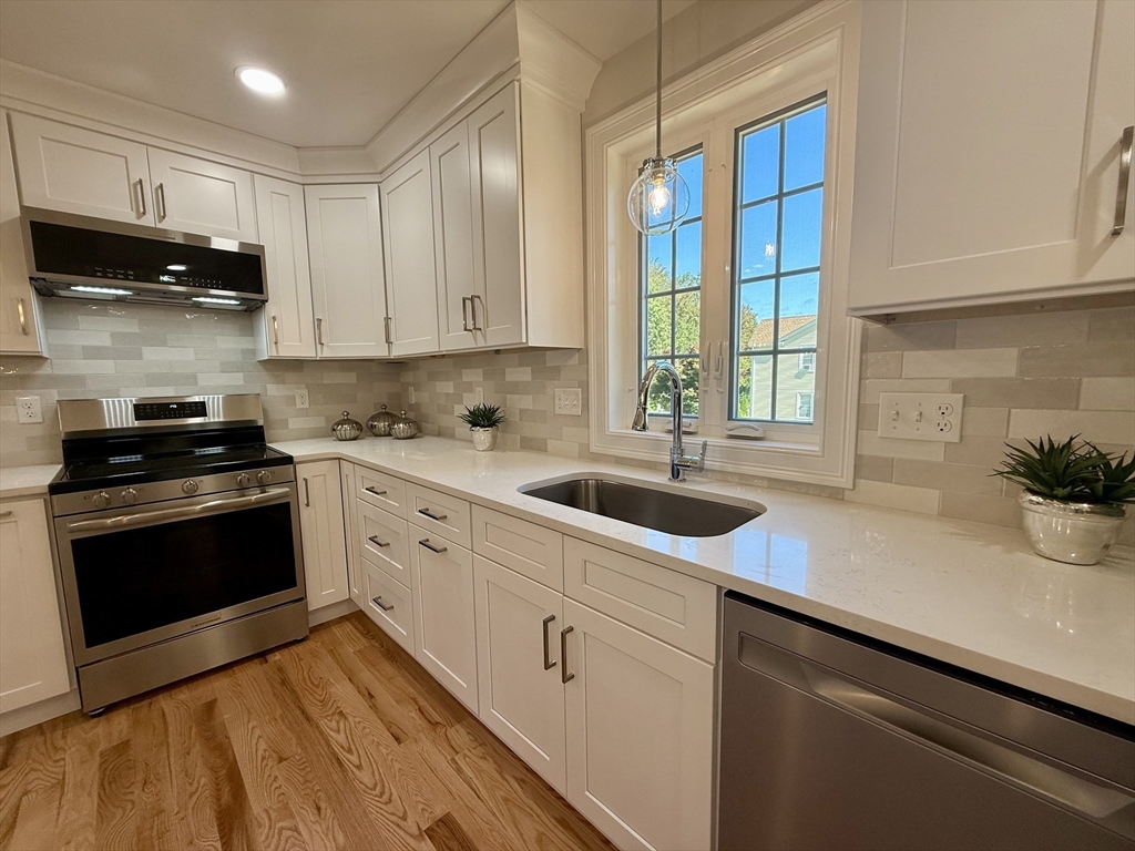 111 Harris Pond Road Blackstone, MA 01504 - Photo 11 of 39 a kitchen with stainless steel appliances white cabinets a sink and a stove