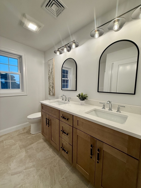 111 Harris Pond Road Blackstone, MA 01504 - Photo 24 of 39 a spacious bathroom with a double vanity sink double mirror and toilet