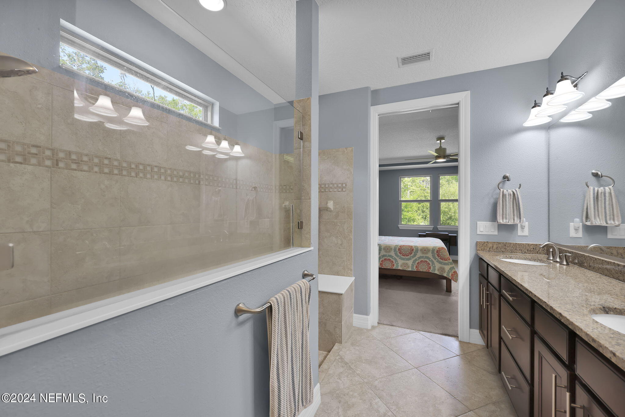48 Eagle Crest Lane Ponte Vedra, FL 32081 - Photo 21 of 94 a en suite bathroom with a granite countertop sink a toilet a mirror and shower
