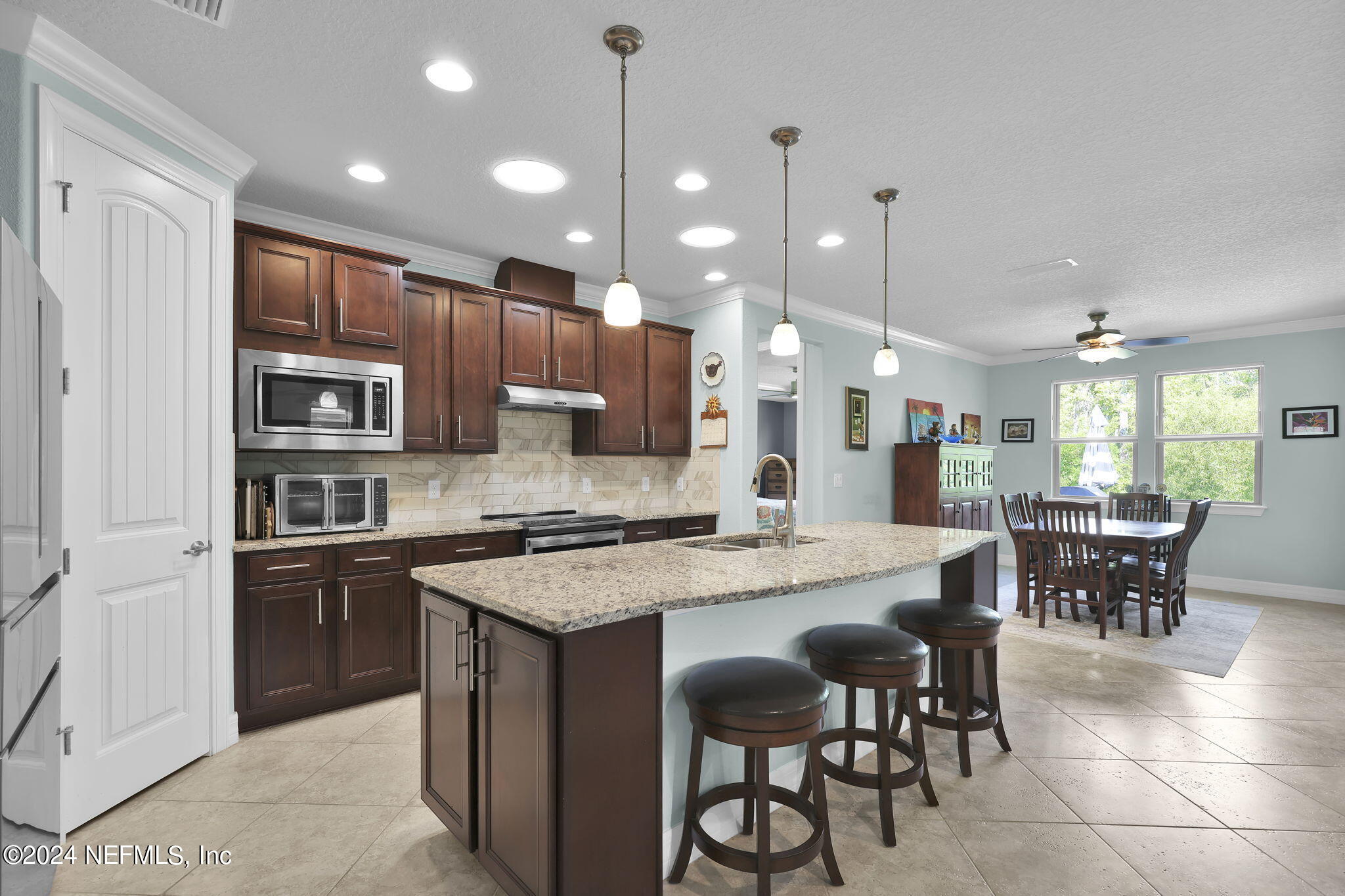 48 Eagle Crest Lane Ponte Vedra, FL 32081 - Photo 9 of 94 a kitchen with stainless steel appliances granite countertop a stove a sink a oven a dining table and chairs
