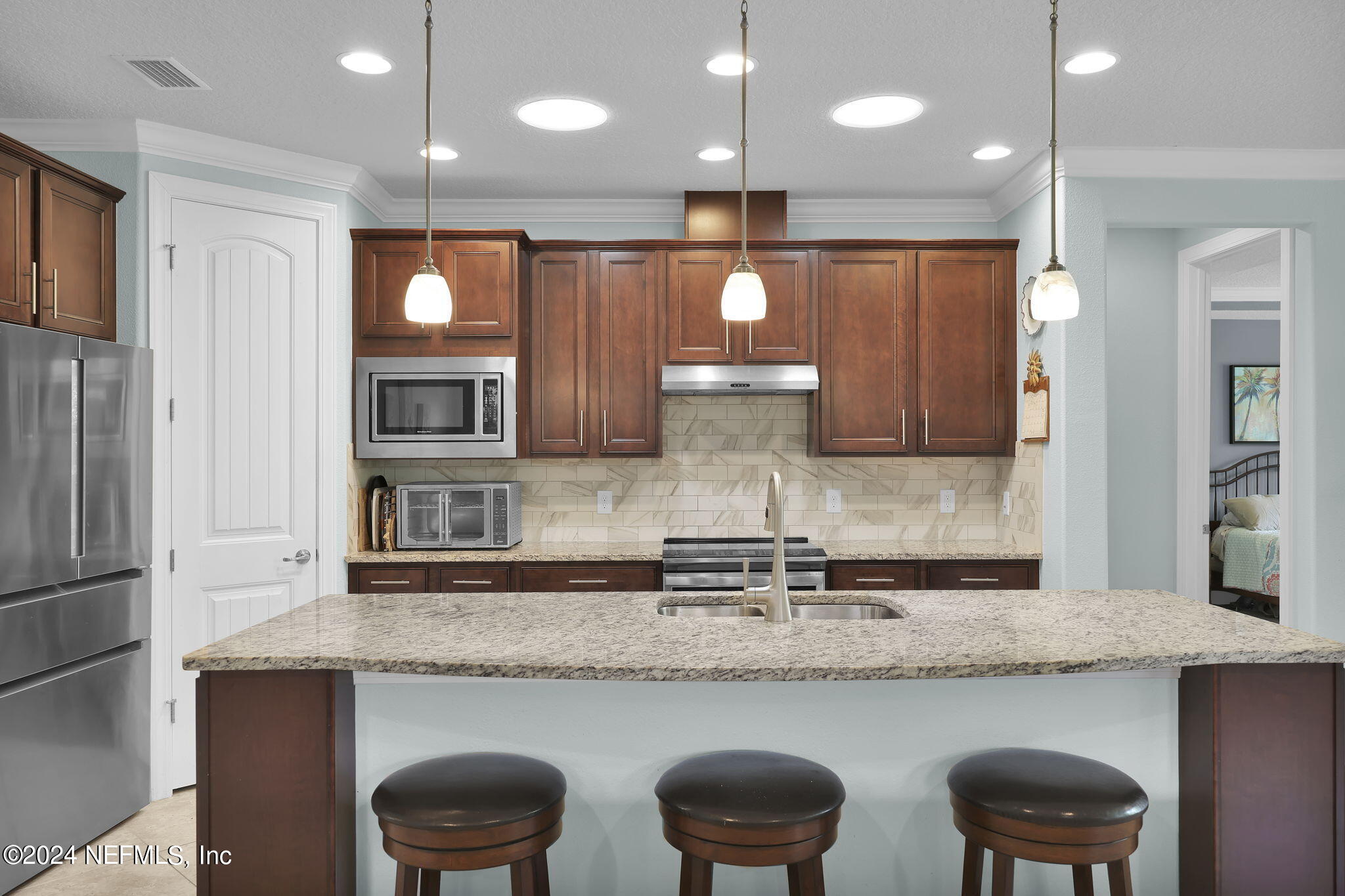 48 Eagle Crest Lane Ponte Vedra, FL 32081 - Photo 10 of 94 a kitchen with granite countertop kitchen island stainless steel appliances a sink and a refrigerator