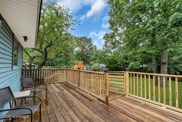a view of a roof deck with wooden floor and fence