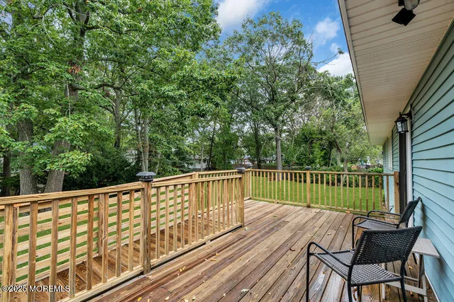 a view of balcony with wooden floor and outdoor seating