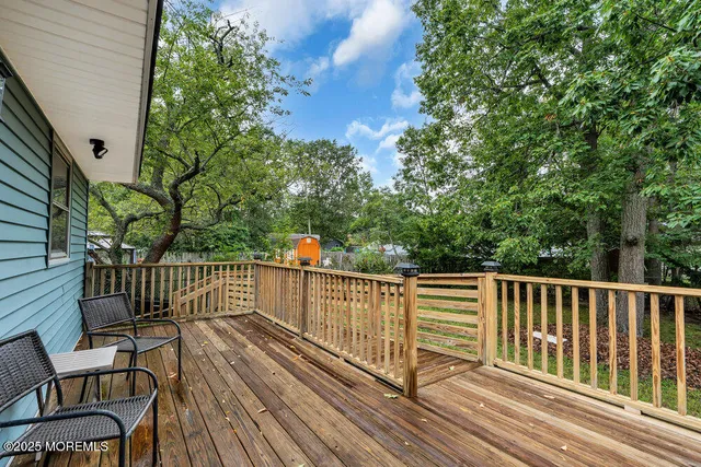 a view of a roof deck with wooden floor and fence