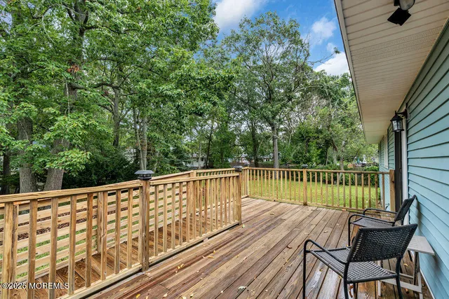 a view of balcony with wooden floor and seating space