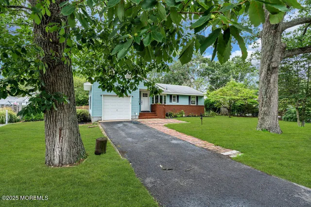 a view of house with outdoor space and garden