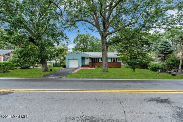a view of house with outdoor space and trees