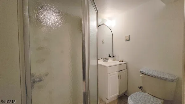 a bathroom with a sink and mirror with toilet