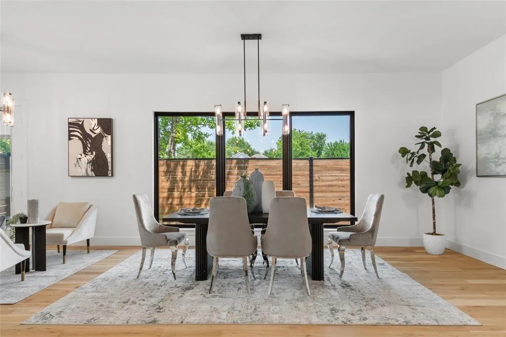 309 Kaye Street Coppell, TX 75019 - Photo 14 of 36 Dining area featuring light wood-finish flooring, white walls, and a contemporary linear chandelier