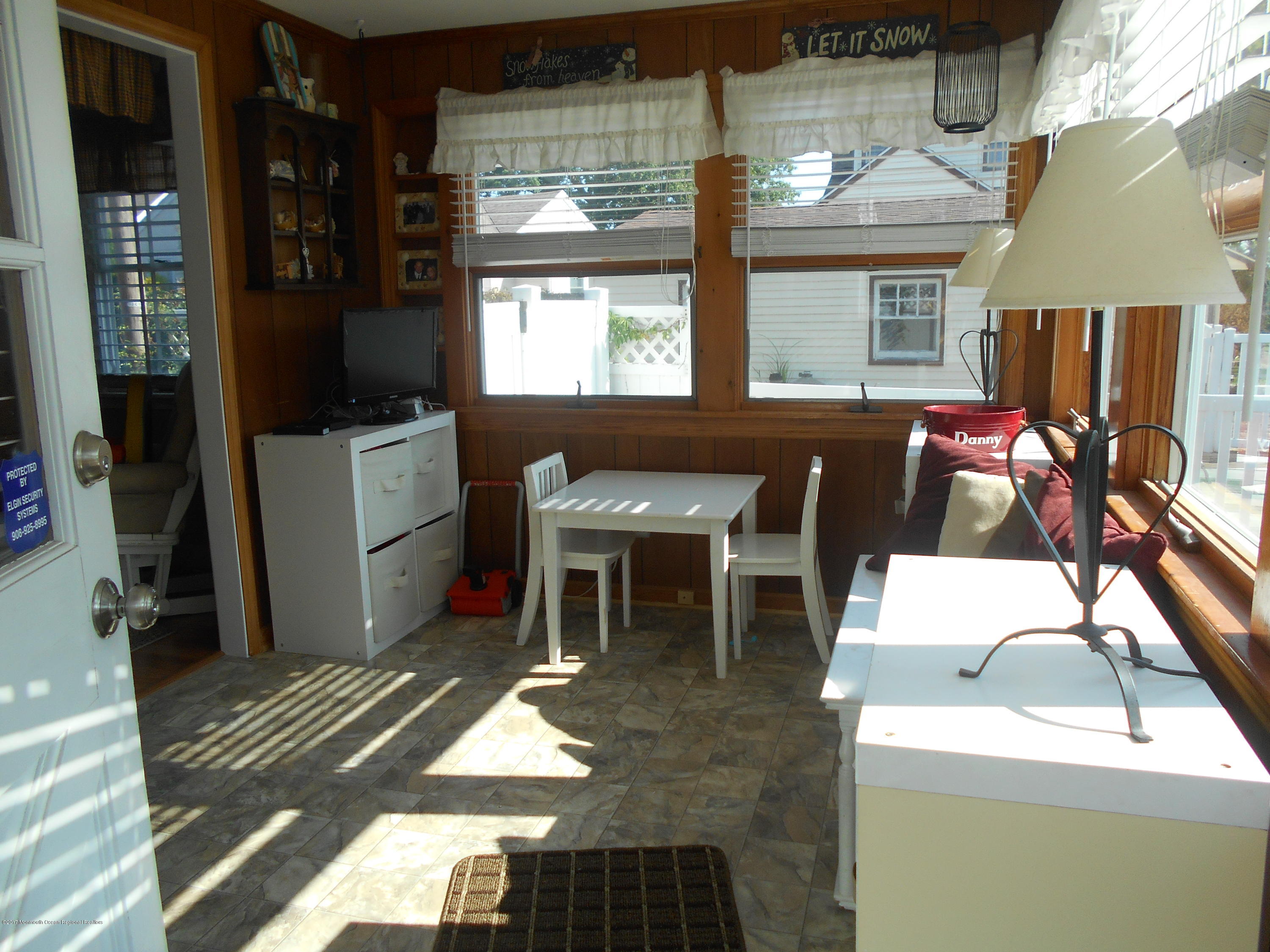 28 Hulse Landing Road Brick, NJ 08723 - Photo 15 of 19 a living room with a couch and a dining table with wooden floor