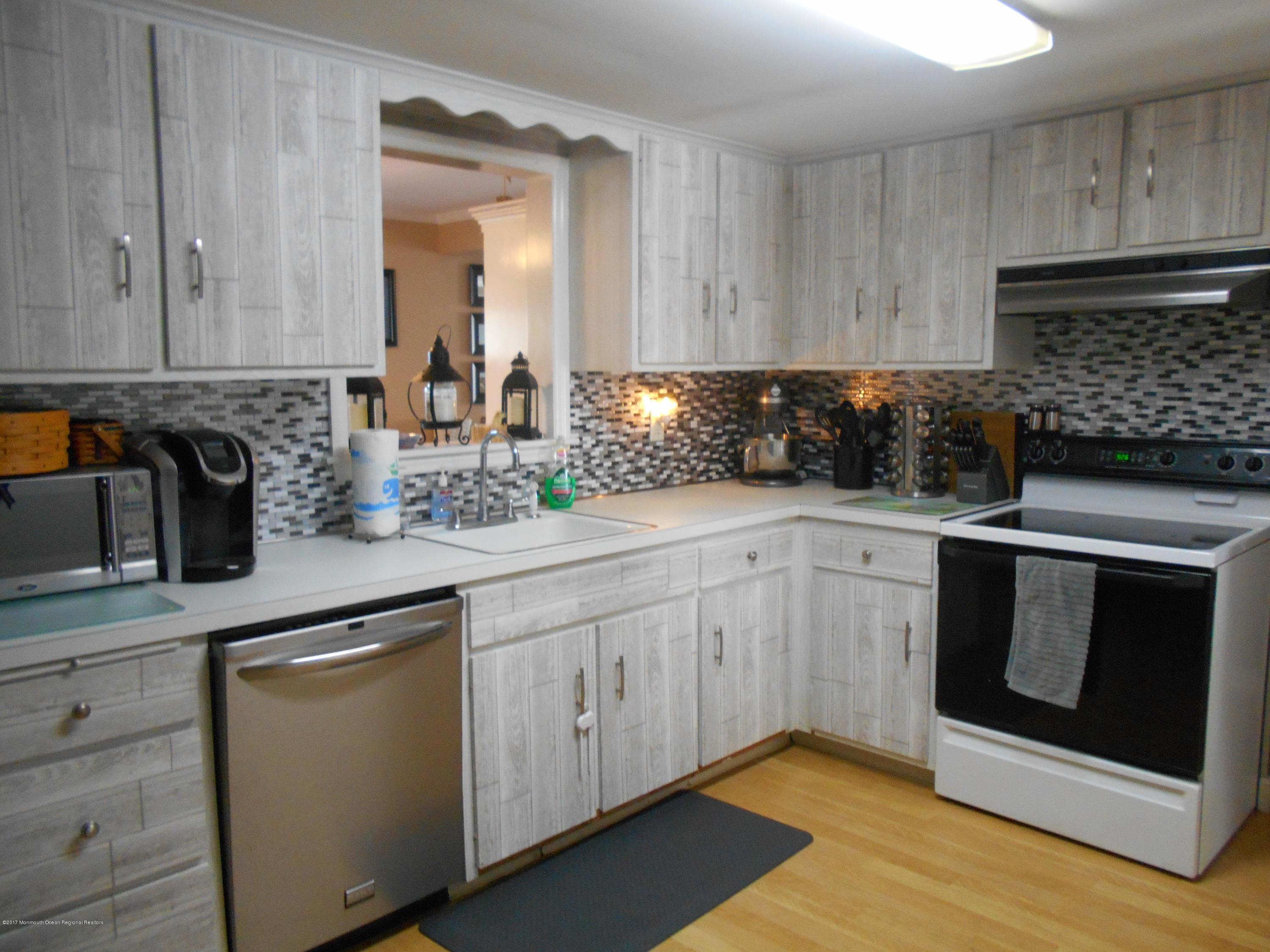 28 Hulse Landing Road Brick, NJ 08723 - Photo 4 of 19 a kitchen with a sink stove and cabinets