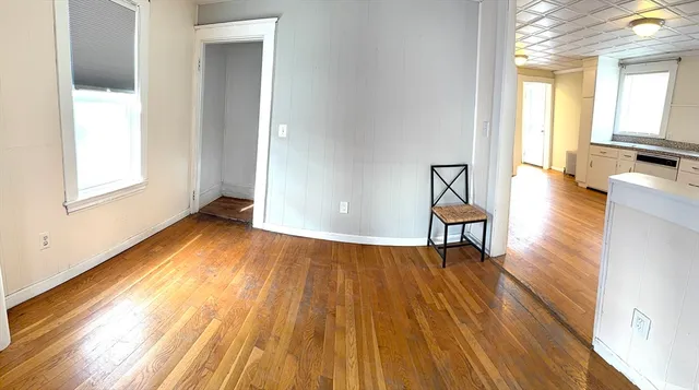 a view of a room with wooden floor and a window