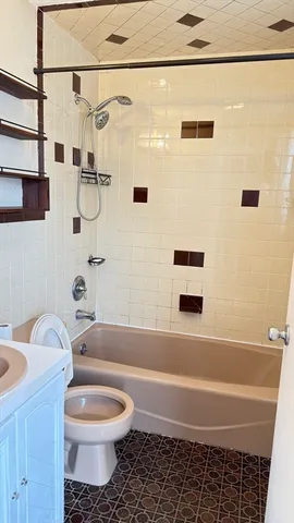 a bathroom with a toilet a sink and bathtub