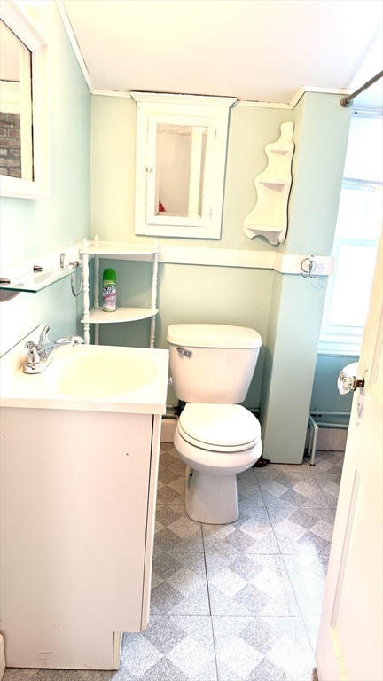 930 Sea Street Quincy, MA 02169 - Photo 17 of 29 a bathroom with a toilet a sink and a mirror