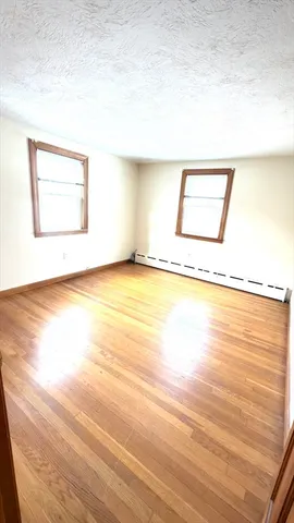 a view of a room with wooden floor