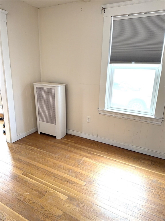 930 Sea Street Quincy, MA 02169 - Photo 22 of 29 a view of an empty room with wooden floor and a window