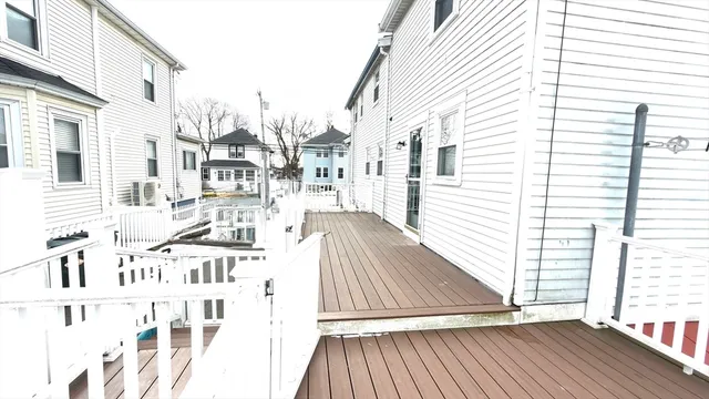 a view of a balcony with wooden floor and fence